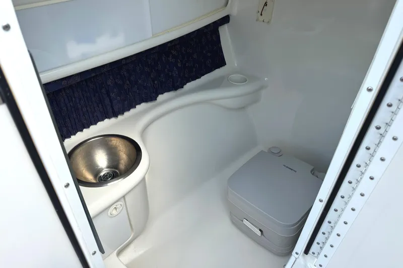 Slide: The Image of 2001 Formula 280 Bowrider boat interior with sink and cup holders. - 24