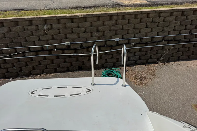 Slide: The Image of 2001 Formula 280 Bowrider boat with swim platform and ladder, docked under clear skies. - 6