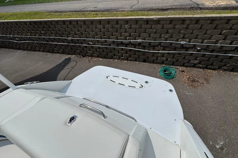 Slide: The Image of 2001 Formula 280 Bowrider boat with swim platform and ladder, docked under a clear sky. - 7