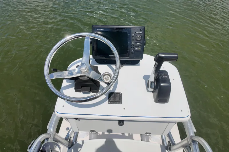 Slide: The Image of Steering console of 2006 Pathfinder 2200 Tournament Edition boat on water. - 12