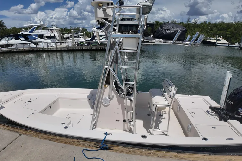 Slide: The Image of 2006 Pathfinder 2200 Tournament Edition boat docked at marina, clear sky, calm water. - 14