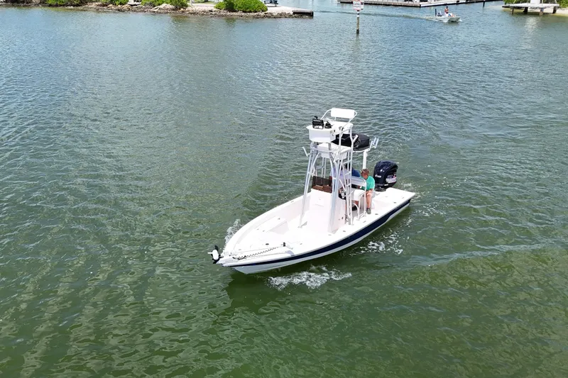 Slide: The Image of 2006 Pathfinder 2200 Tournament Edition boat cruising on a calm waterway. - 16