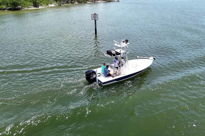 Slide: The Image of 2006 Pathfinder 2200 Tournament Edition boat cruising on a calm waterway. - 17