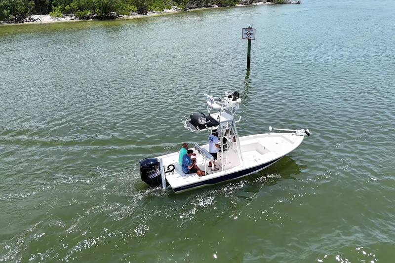Slide: The Image of 2006 Pathfinder 2200 Tournament Edition boat cruising in calm waters near a shoreline. - 5