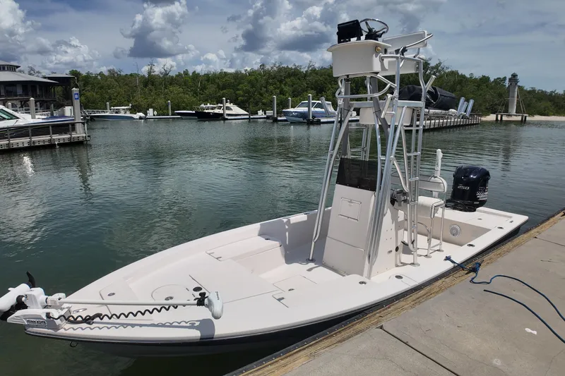 Slide: The Image of 2006 Pathfinder 2200 Tournament Edition boat docked at marina under cloudy sky. - 7