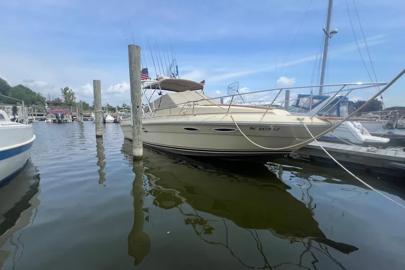 Slide: The Image of 1986 Sea Ray 270 Amberjack docked at a marina on a sunny day. - 1