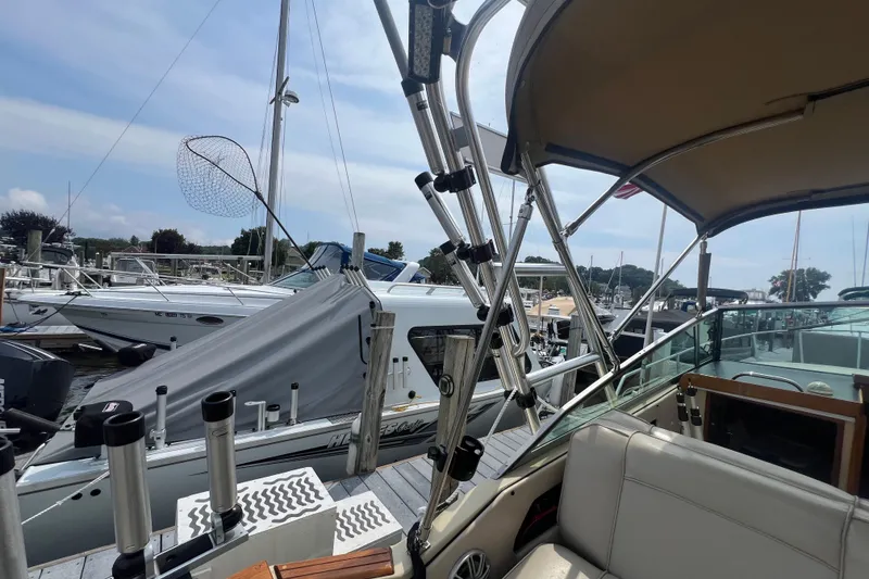 Slide: The Image of 1986 Sea Ray 270 Amberjack boat docked at marina with fishing gear. - 16