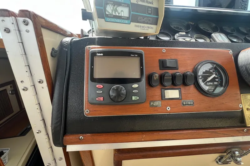 Slide: The Image of Control panel of a 1986 Sea Ray 270 Amberjack boat with gauges and switches. - 20