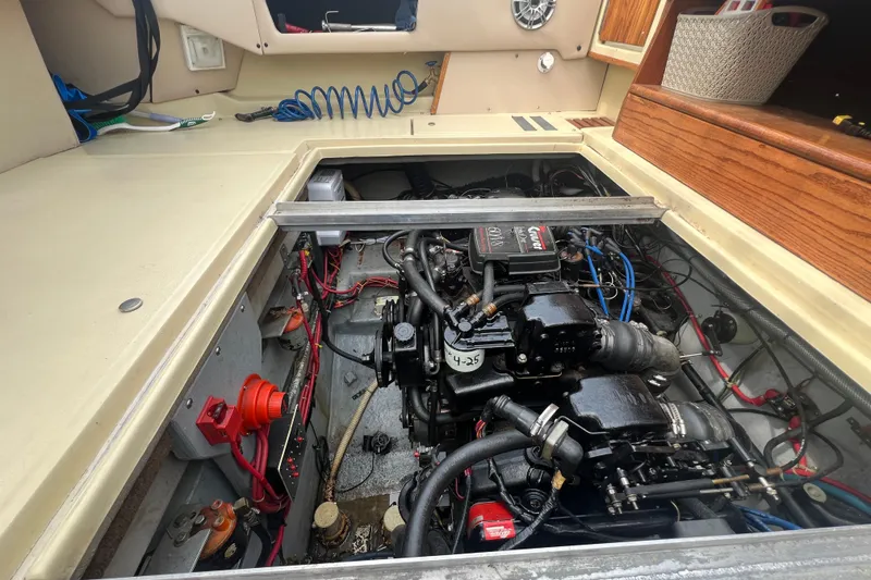 Slide: The Image of Engine compartment of a 1986 Sea Ray 270 Amberjack boat, showcasing detailed mechanical components. - 25