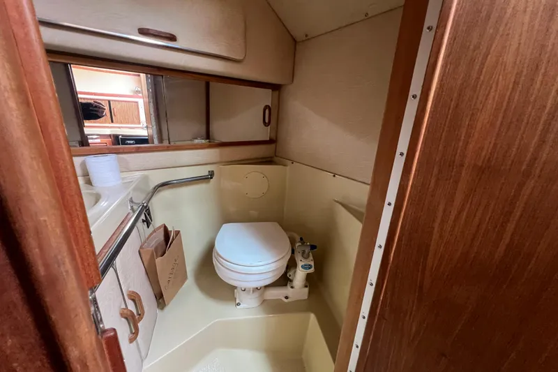 Slide: The Image of 1986 Sea Ray 270 Amberjack boat bathroom with toilet and sink. - 30