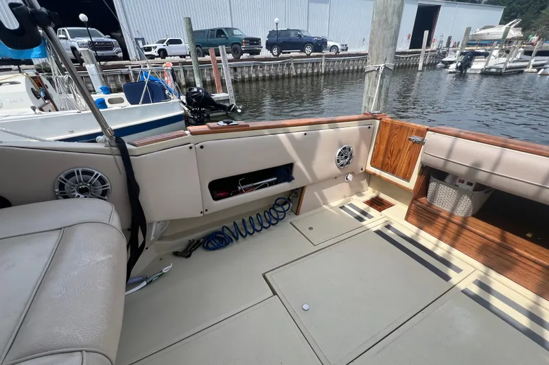 Slide: The Image of 1986 Sea Ray 270 Amberjack boat interior with seating, storage, and dockside view. - 5
