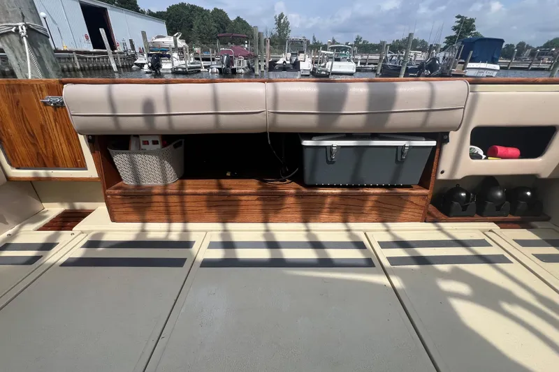 Slide: The Image of 1986 Sea Ray 270 Amberjack boat interior with storage compartments and cooler. - 6