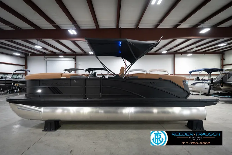 Slide: The Image of 2026 Bennington 22 MFB pontoon boat in showroom, featuring sleek design and canopy. - 10