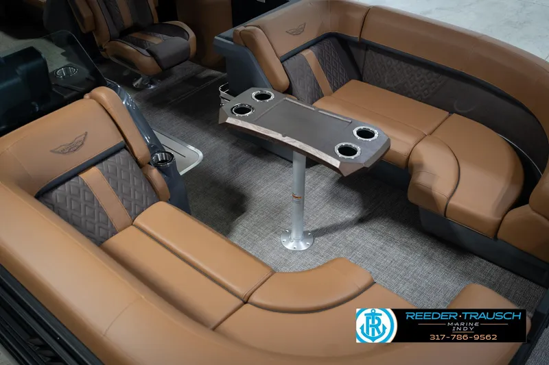 Slide: The Image of 2026 Bennington 22 MFB boat interior with luxurious tan seating and central table. - 11