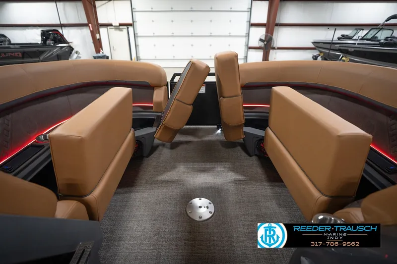 Slide: The Image of Interior of 2026 Bennington 22 MFB boat with tan seating and ambient lighting. - 22