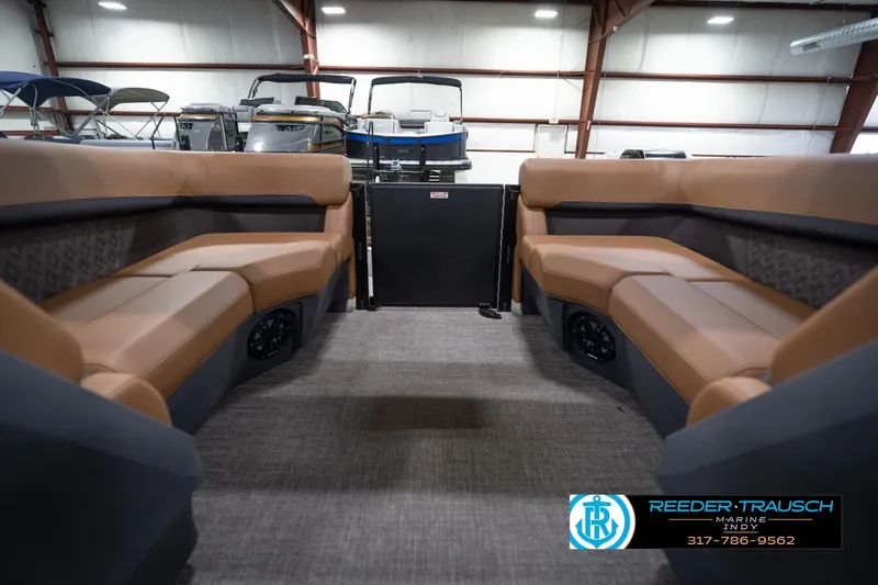 Slide: The Image of 2026 Bennington 22 MFB pontoon boat interior with tan seating in showroom. - 25