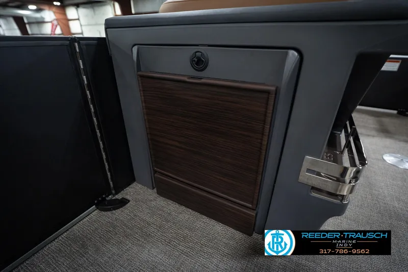 Slide: The Image of 2026 Bennington 22 MFB boat interior detail with wood paneling and storage compartment. - 29
