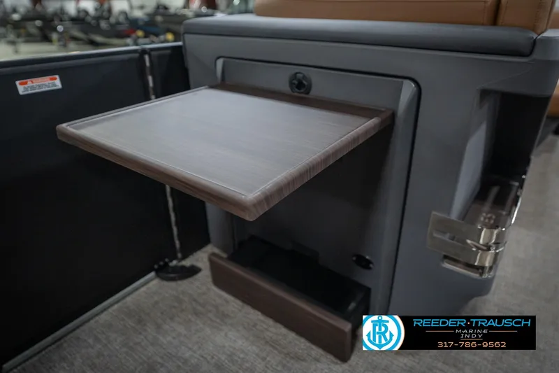 Slide: The Image of 2026 Bennington 22 MFB boat interior with fold-out table and storage compartment. - 31