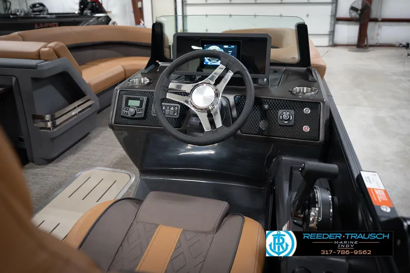 Slide: The Image of 2026 Bennington 22 MFB boat interior with steering wheel and control panel. - 32