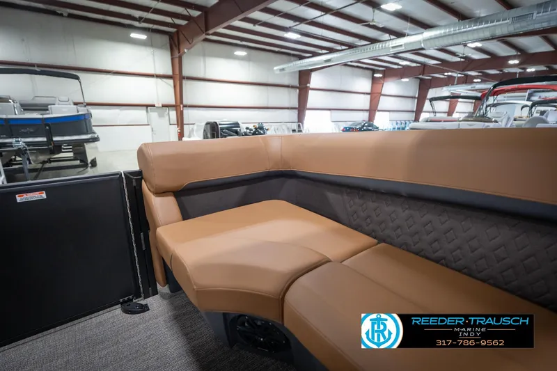 Slide: The Image of 2026 Bennington 22 MFB boat interior with tan seating in a showroom. - 41