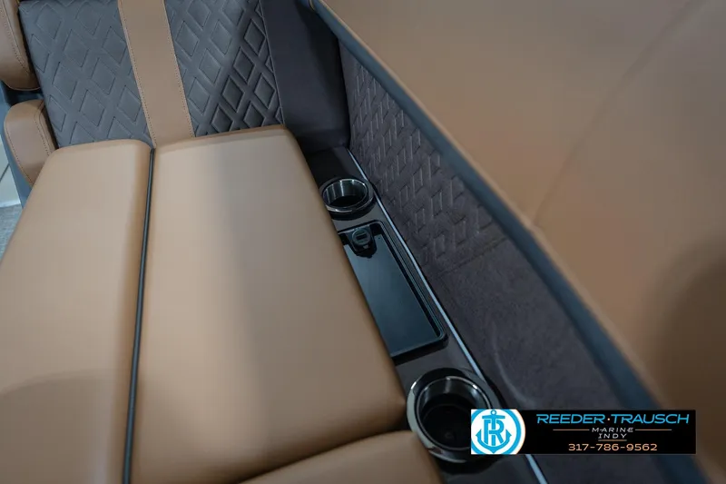 Slide: The Image of 2026 Bennington 22 MFB interior with brown leather seats and cup holders. - 47