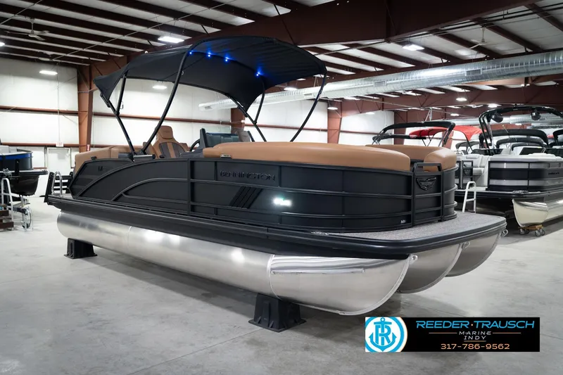Slide: The Image of 2026 Bennington 22 MFB pontoon boat in showroom with canopy and sleek design. - 5