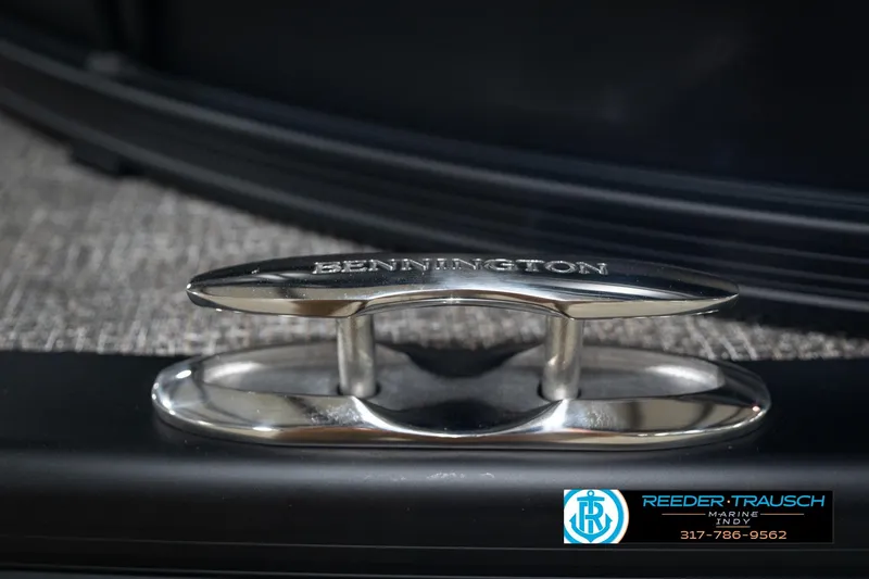 Slide: The Image of Close-up of a Bennington 22 MFB 2026 boat cleat with Reeder-Trausch Marine contact details. - 54