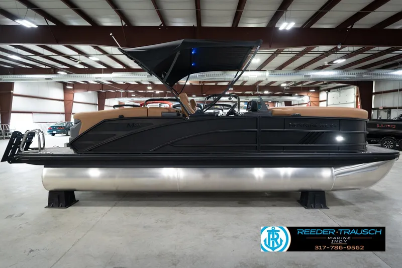 Slide: The Image of 2026 Bennington 22 MFB pontoon boat in showroom with sleek black design. - 6