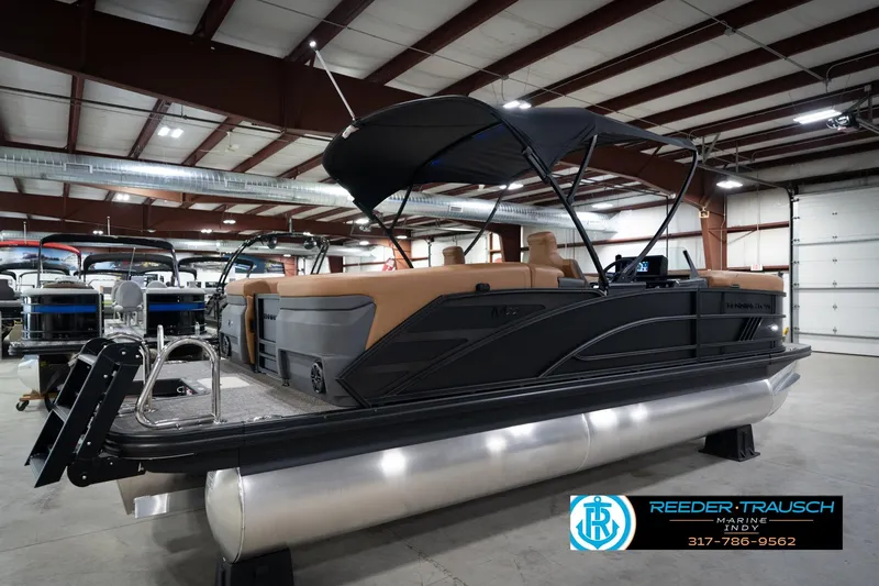 Slide: The Image of 2026 Bennington 22 MFB pontoon boat in showroom with canopy and seating. - 7