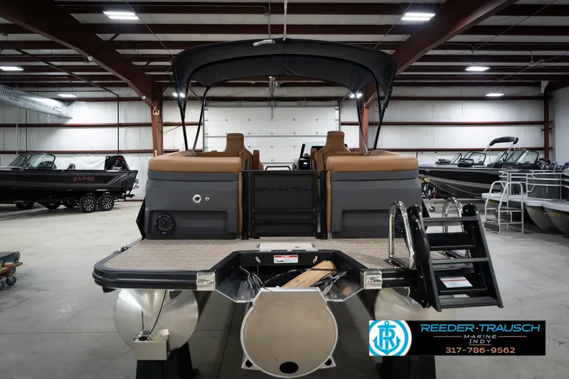 Slide: The Image of 2026 Bennington 22 MFB pontoon boat in showroom, featuring sleek design and modern amenities. - 8