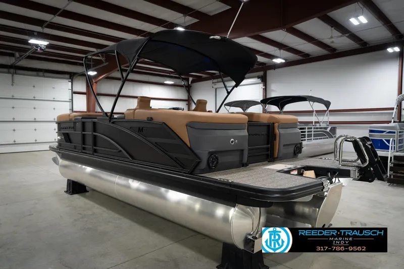 Slide: The Image of 2026 Bennington 22 MFB pontoon boat in showroom, featuring sleek design and modern amenities. - 9