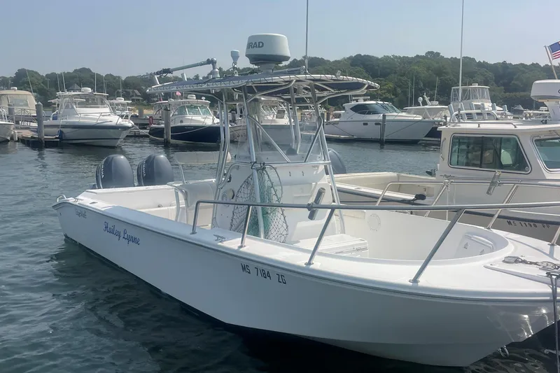 Slide: The Image of Edgewater 247CC 2002 boat docked in marina with other vessels. - 3