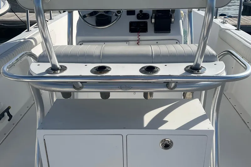 Slide: The Image of Edgewater 247CC 2002 boat console with rod holders and seating. - 6