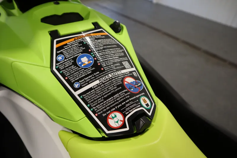 Slide: The Image of 2023 Sea-Doo SPARK 3 IBR CONV SS with safety instructions on vibrant green body. - 15