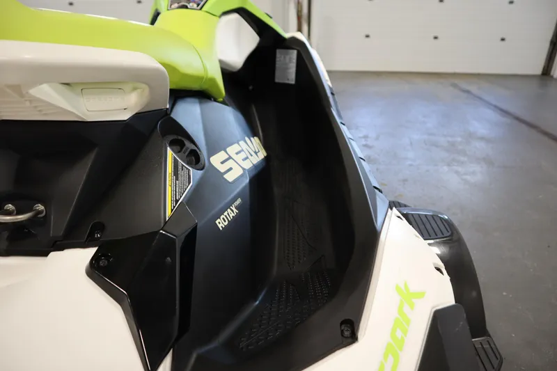 Slide: The Image of 2023 Sea-Doo SPARK 3 IBR CONV SS, close-up of seat and branding in a garage. - 18