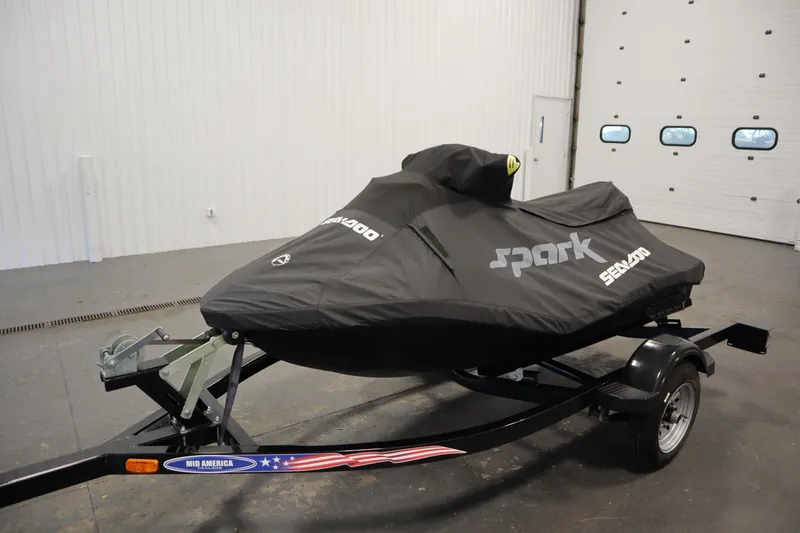 Slide: The Image of 2023 Sea-Doo SPARK 3 IBR CONV SS jet ski covered on trailer in garage. - 29