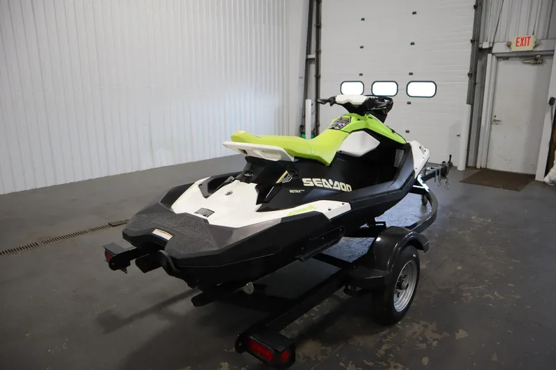 Slide: The Image of 2023 Sea-Doo SPARK 3 IBR CONV SS on trailer in garage setting. - 34