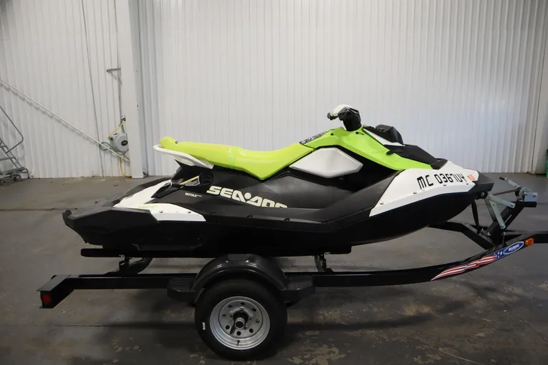 Slide: The Image of 2023 Sea-Doo SPARK 3 IBR CONV SS on trailer, lime green and black design. - 4