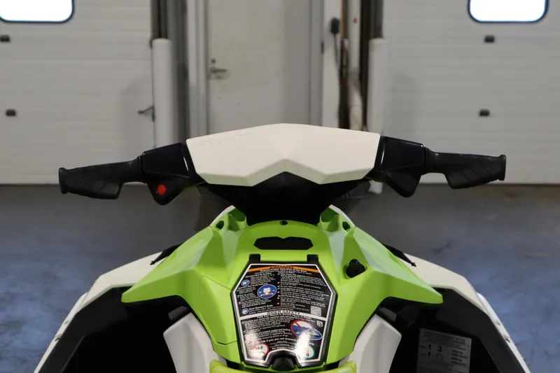 Slide: The Image of 2023 Sea-Doo Spark 3up jet ski with lime green seat on a trailer. - 11