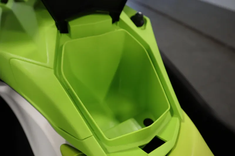 Slide: The Image of 2023 Sea-Doo Spark 3up jet ski with vibrant green seat in a garage setting. - 16