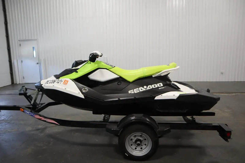 Slide: The Image of 2023 Sea-Doo Spark 3up handlebars and dashboard in a garage setting. - 8