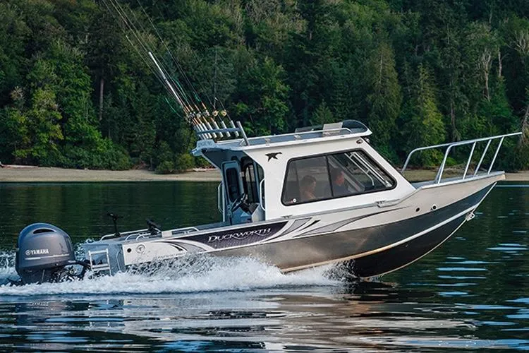 Slide: The Image of 2026 Duckworth 24 Pacific Pro boat interior with seating and rod holders under a clear blue sky. - 4