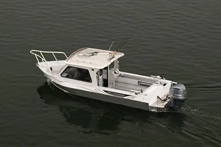 Slide: The Image of 2026 Duckworth 24 Pacific Pro boat interior with seating and storage, parked outdoors. - 7