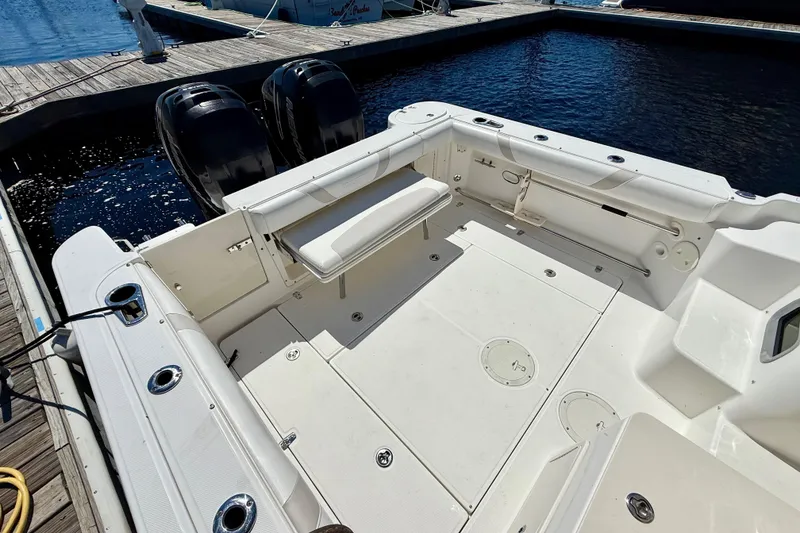 Slide: The Image of 2007 Boston Whaler 285 Conquest boat deck with twin engines at marina. - 11