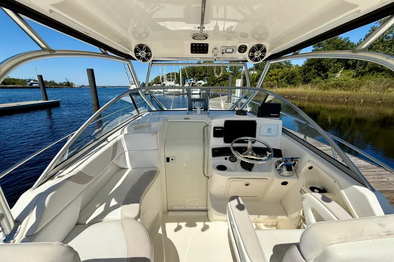 Slide: The Image of 2007 Boston Whaler 285 Conquest boat interior with helm, seating, and water view. - 15