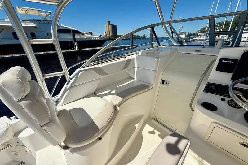 Slide: The Image of 2007 Boston Whaler 285 Conquest cockpit with white seating and steering console. - 16