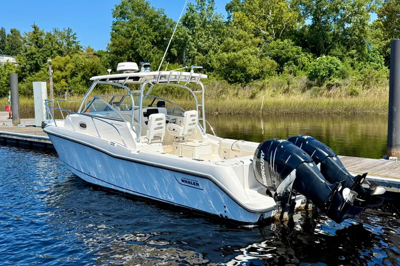 Slide: The Image of 2007 Boston Whaler 285 Conquest boat docked with twin Mercury engines. - 4