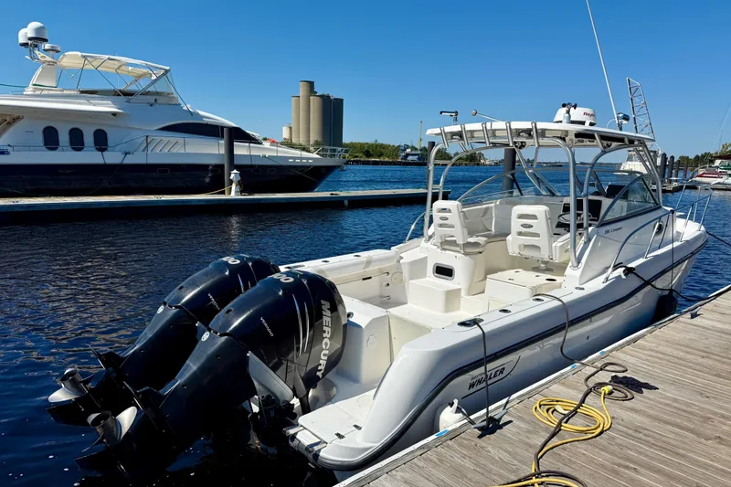 Slide: The Image of 2007 Boston Whaler 285 Conquest boat docked with twin Mercury engines. - 6