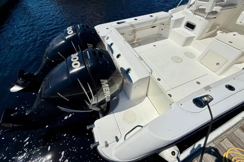 Slide: The Image of 2007 Boston Whaler 285 Conquest with dual Mercury Verado engines docked by water. - 8