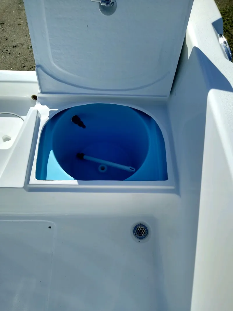 Slide: The Image of Livewell compartment on 2024 Lookout Skiff 23CC boat, open lid, blue interior. - 8